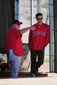 February 21, 2012; Tempe, AZ, USA; Los Angeles Angels manager Mike Scioscia (left) talks to general manager Jerry Dipoto (right) during spring training at Tempe Diablo Stadium. Mandatory Credit: Kyle Terada-USA TODAY Sports