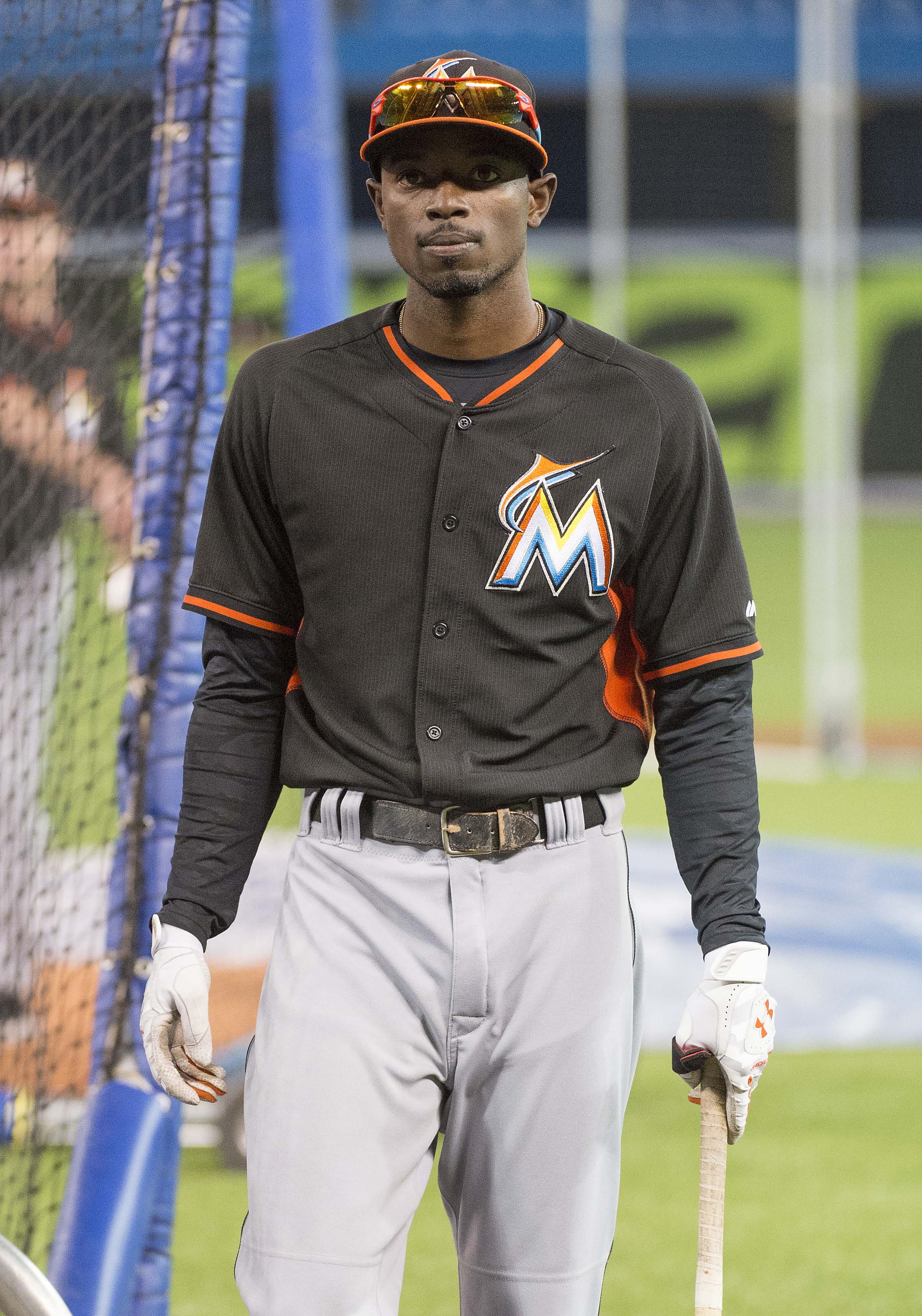 Miami Marlins' Dee Gordon puts on his batting gloves during